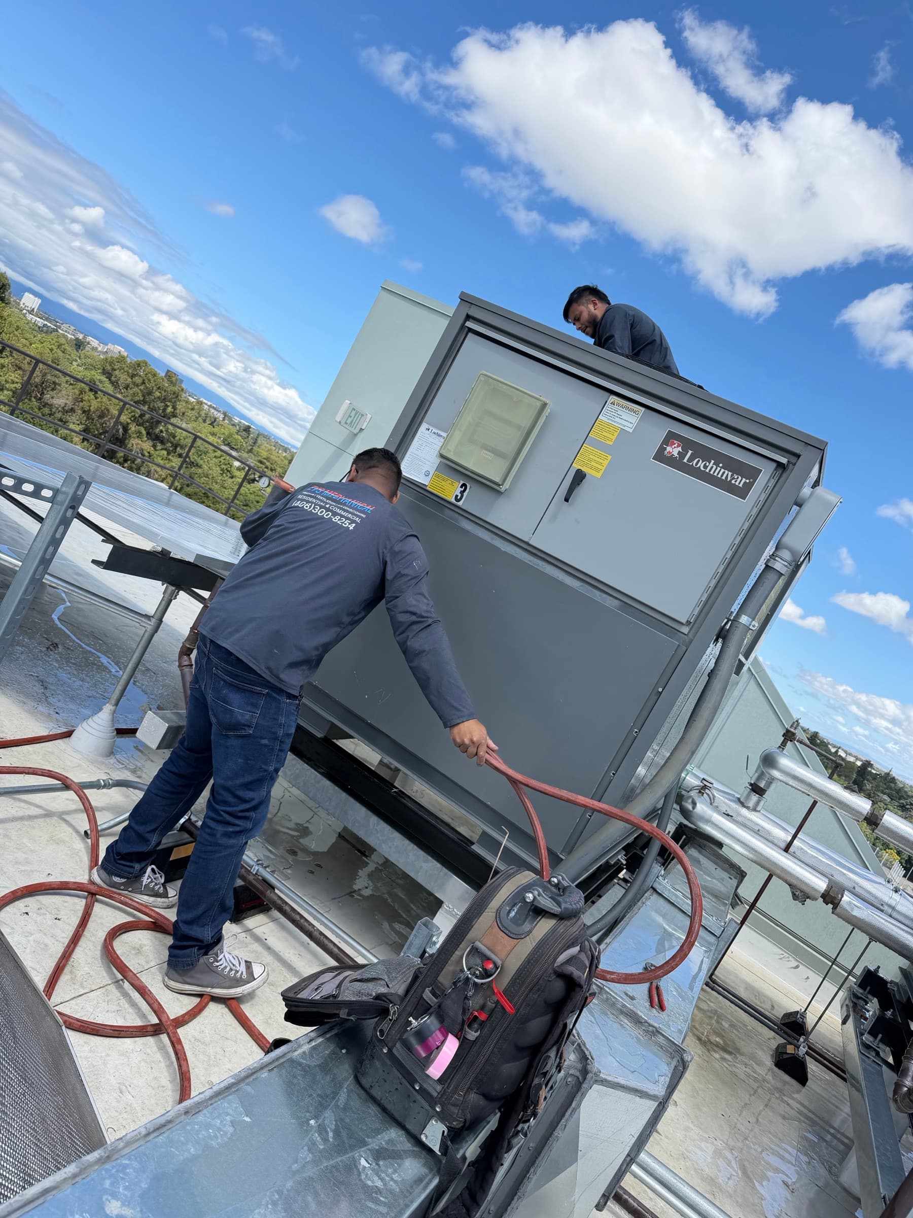 EVS Mechanical technicians servicing rooftop HVAC equipment in the Bay Area