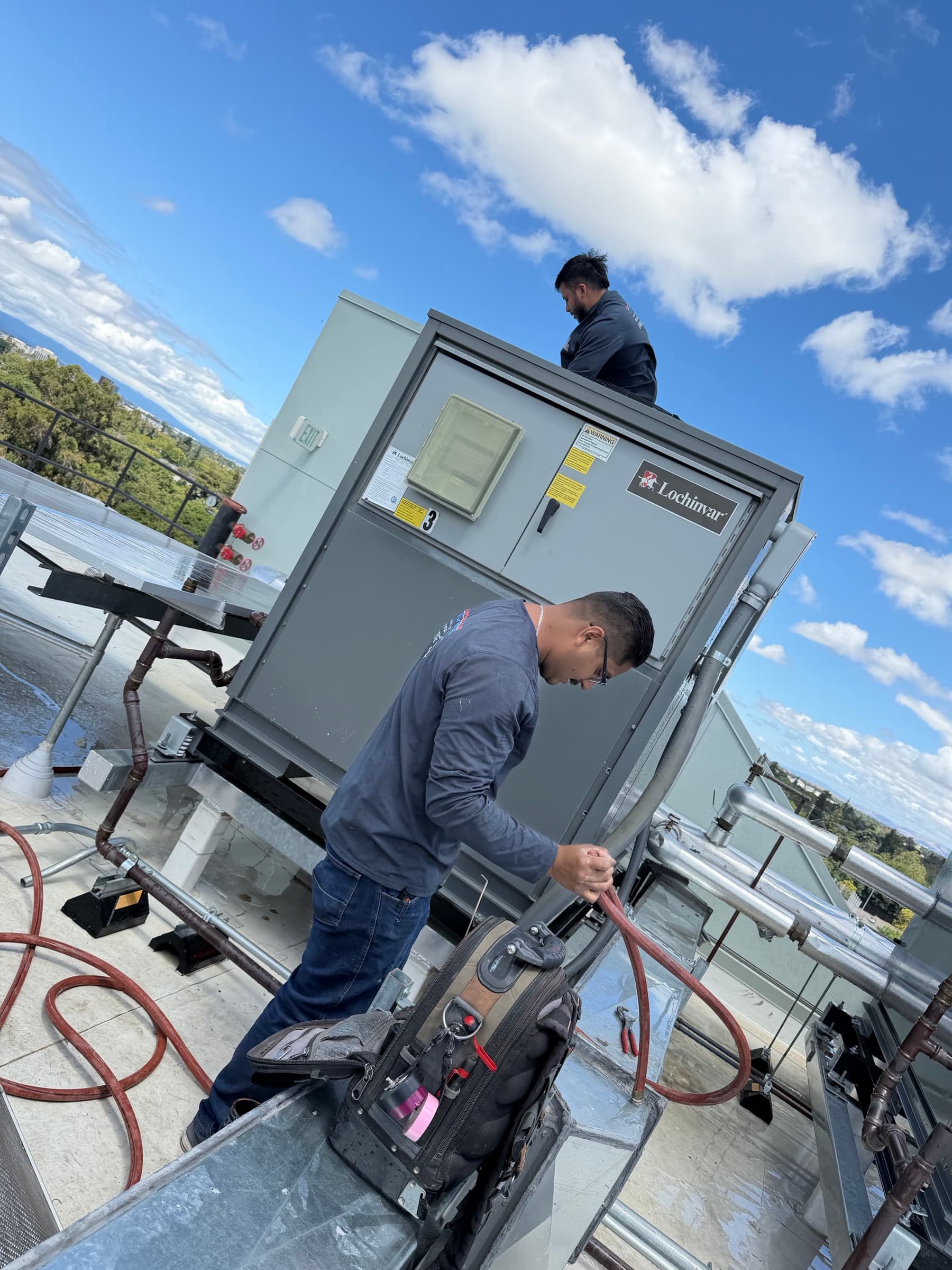EVS Mechanical crew servicing commercial rooftop HVAC equipment